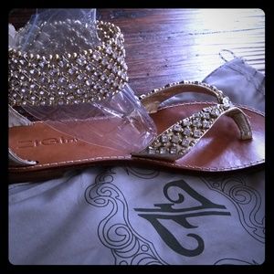 Gold, jeweled sandals.